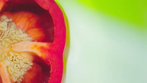 Closeup. Red pepper cut in half on a rotating green background. Copy space. top 動画素材 130526962