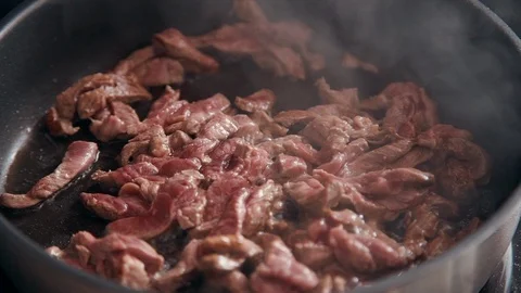 Closeup red pieces beef fried in frying pan. sliced meat roasting with oil Video stock 123284910