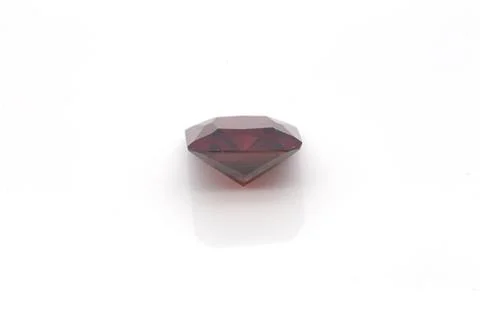 Closeup of a red ruby gemstone isolated on a white background Stock Photos