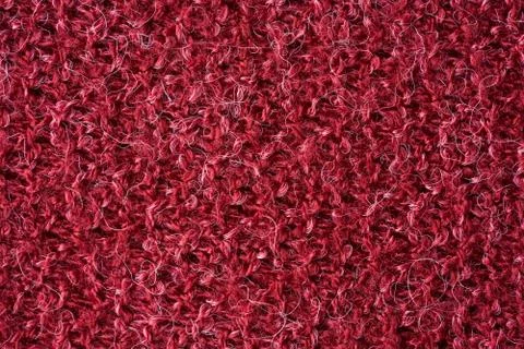 Closeup red texture of woolen knitted fabric. Pattern of red fabric. Stock Photos
