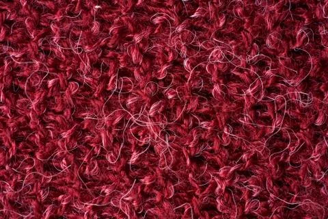 Closeup red texture of woolen knitted fabric. Pattern of red fabric. Stock Photos