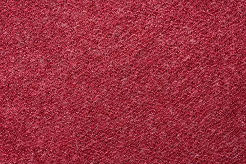 Closeup red texture of woolen knitted fabric. Pattern of red fabric. Stock Photos