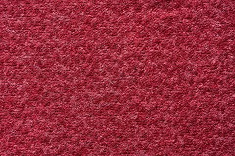 Closeup red texture of woolen knitted fabric. Pattern of red fabric. Stock Photos