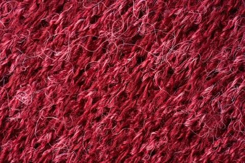 Closeup red texture of woolen knitted fabric. Pattern of red fabric. Stock Photos