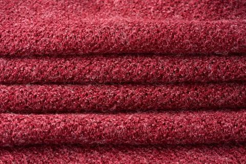 Closeup red texture of woolen knitted fabric. Pattern of several layers of re Stock Photos