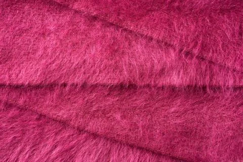Closeup red texture of woolen knitted fabric. Pattern of several layers of re Stock Photos