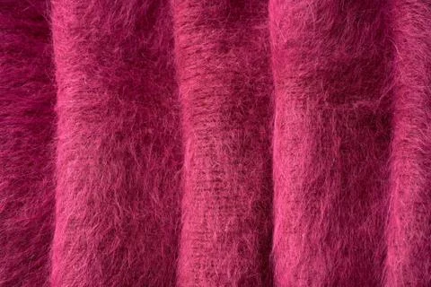 Closeup red texture of woolen knitted fabric. Pattern of several layers of re Stock Photos