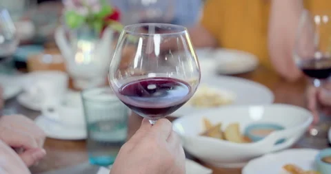 Closeup of red wine glass during senior Asian women reunion at restaurant, Stock Footage 337011612