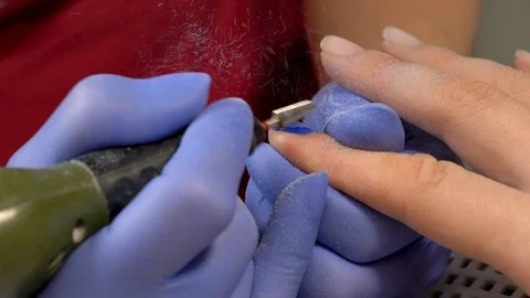 Closeup of removing old nail polish using electric manicure drill machine.  Stock Footage 90276804