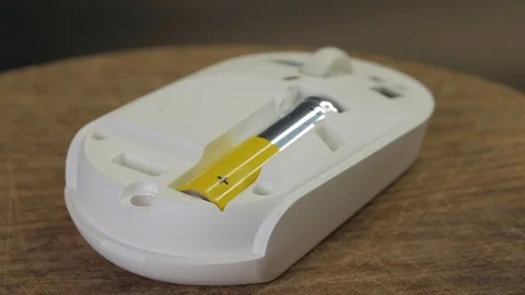 Closeup of the replacement battery into the wireless computer mouse Stock Footage 123631567
