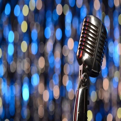 Closeup of retro microphone with blurred lights at background Stock Footage 69605495