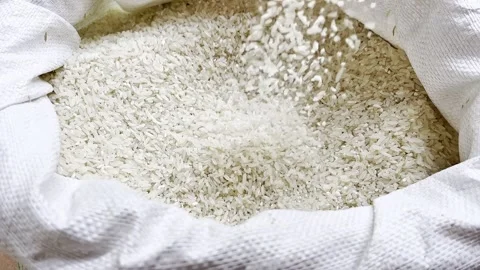 Closeup of rice falling into a sack Stock Footage 339077975