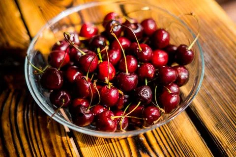 Closeup of ripe red cherries lying on a table Stock Photos