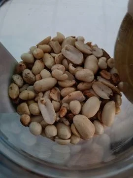 Closeup of roasted peanut in opened jar Stock Photos
