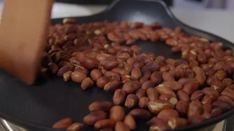 A closeup of roasting peanut on stove Stock Footage 306063841