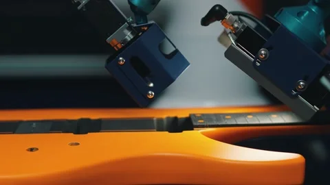 Closeup of the robot arm checking the yellow guitar, musical instrument and 库存影片 274472776
