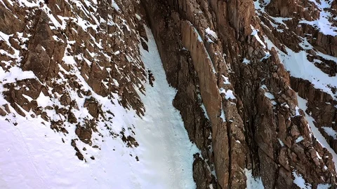 Closeup rocks and snow on the mountain side. Large mountains and rocks. Stock Footage 119044646