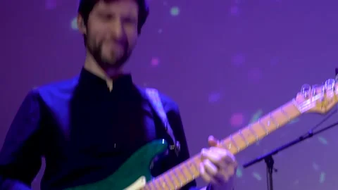 Closeup rockstar on stage playing an electro guitar. Male guitarist. Kyiv Stock Footage 220806112