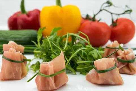 Closeup of rolled ham and raw vegetables Stock Photos