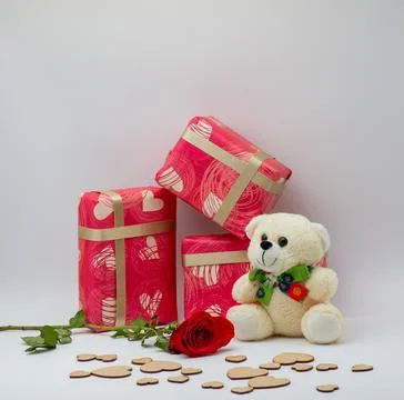 Closeup of rose ,Wrapped gift boxes and a teddy isolated on a white backgroun Stock Photos