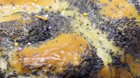 Closeup rotates sweet yellow Easter cupcake decorated with poppy seeds, 4K Stock Footage 195176537