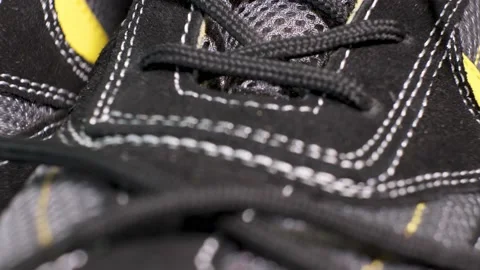 Closeup of rotating pair of black protective working boots with laces. Stock Footage 140466532