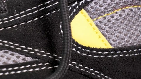 Closeup of rotating pair of black protective working boots with laces. Stock Footage 140562361