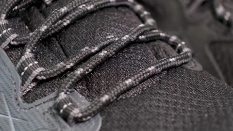 Closeup of rotating pair of black tracking boots with laces. Stock Footage 140488254