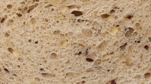 Closeup rotating shot of multigrain bread texture showing seeds and air bubbles 스톡 동영상 313794572
