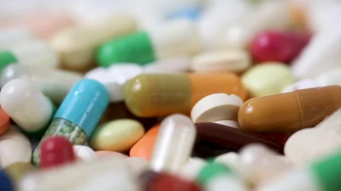 Closeup rotating shot of pile of colorful medicine pills Stock Footage 124121853
