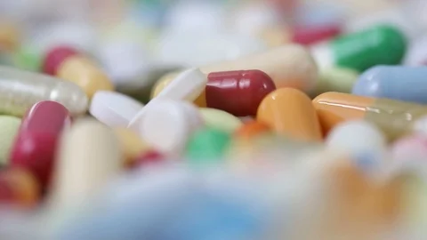 Closeup rotating shot of pile of many different pills Stock Footage 124636365