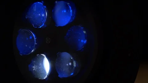 Closeup rotating snowflake projector, phantom blue color Stock Footage 122982498
