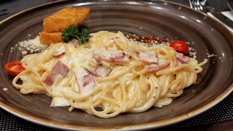 Closeup Rotating Spaghetti Carbonara Alfredo With Creamy Cheese Sauce or Parsley Stock Footage 317945375