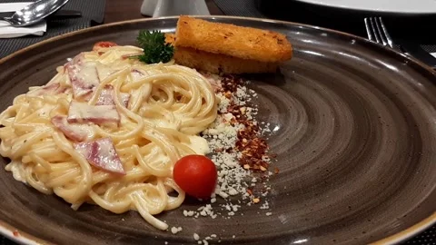 Closeup Rotating Spaghetti Carbonara Alfredo With Creamy Cheese Sauce or Parsley Video stock 317945512