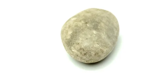Closeup rotating video of natural rounded grey stone Stock Footage 83650006