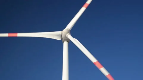 Closeup of a rotating wind turbine on blue sky. Stock Footage 145953979