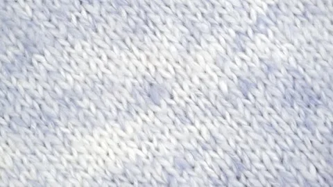 Closeup rotation texture of wool knitted white blue fabric. abstract background. Stock Footage 240644454