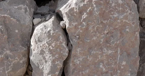 Closeup rough pink and grey rocks with cracks and scratch marks Stock Footage 314463798