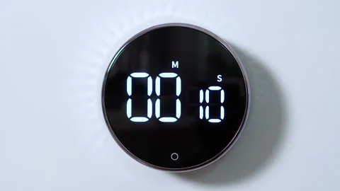 Closeup of round kitchen electronic and mechanical timer is from 15 seconds to 0 Stock Footage 150982136