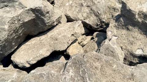 Closeup of rugged textured rocks in natural earthy tones under bright sunli.. Stock-Footage 339368879