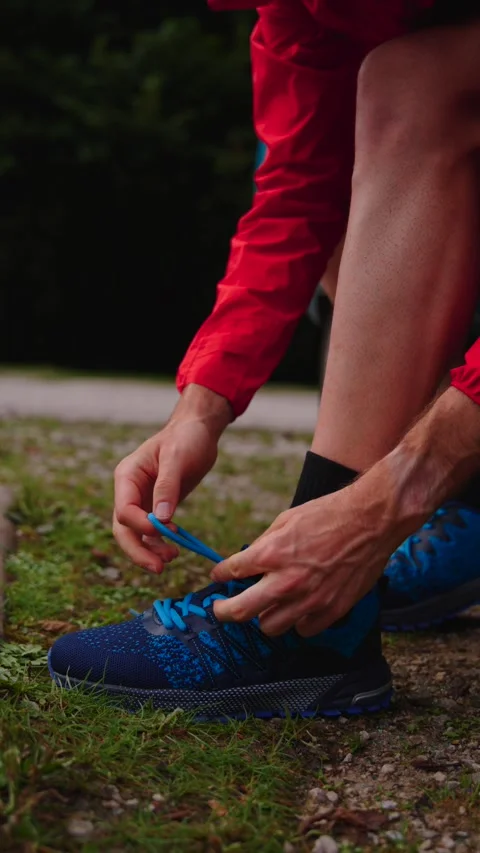 Closeup of runner tying shoelaces Stock Footage 283288448