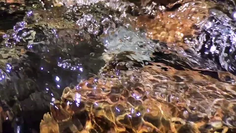 Closeup of rushing water and rocky bottom of a creek bed at Beauty Creek, ID Stock Footage