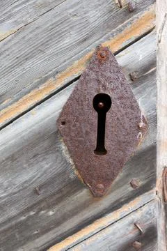 Closeup of rustic empty lock on a wooden door Stock Photos