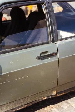 Closeup of a rusty car with a yellow light on its side Stock Photos