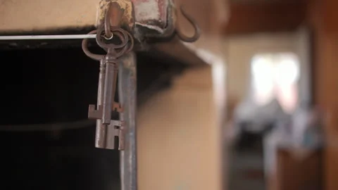 Closeup on rusty keys dangling off hook on workbench.Static shallow Stock Footage 242977927
