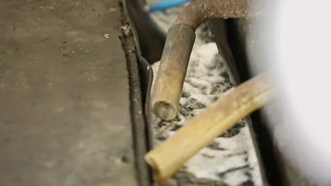 A closeup of a rusty pipe discharges factory wastewater during production Stock Footage 244713436