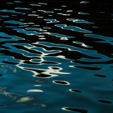 Closeup of s wavy water with the reflection of lunar path on it - copy space Foto stock