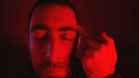 Closeup of sad young man committing suicide with finger gun gesture Video stock 89963011