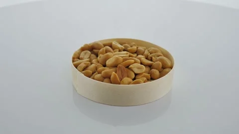 Closeup of salt shooting peanuts, peeled in organic washer, rotation Stock Footage 151652760