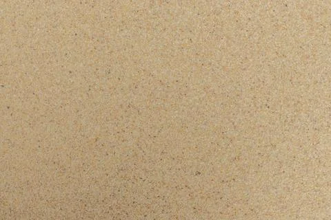 Closeup of sand pattern of a beach in the summer. Beach background. Top view Stock Photos